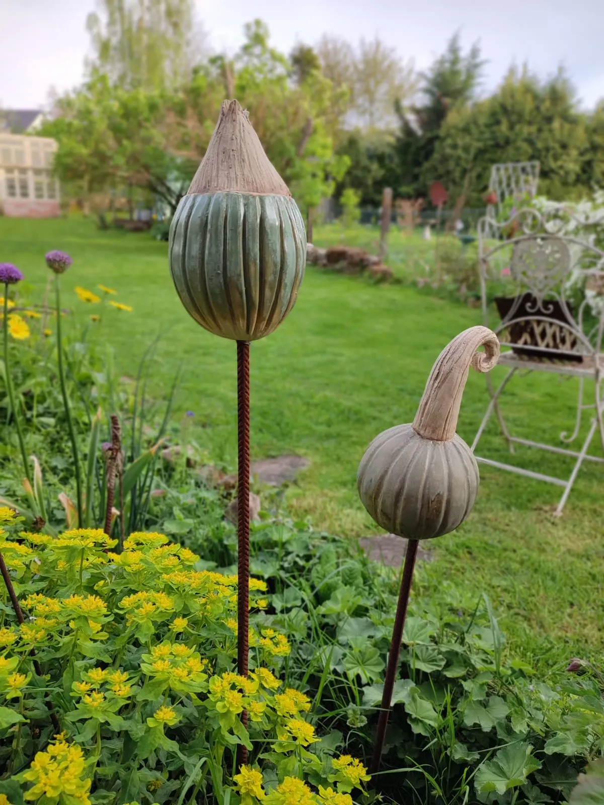 Zwei große Keramik-Mohnkapseln als Gartenstecker